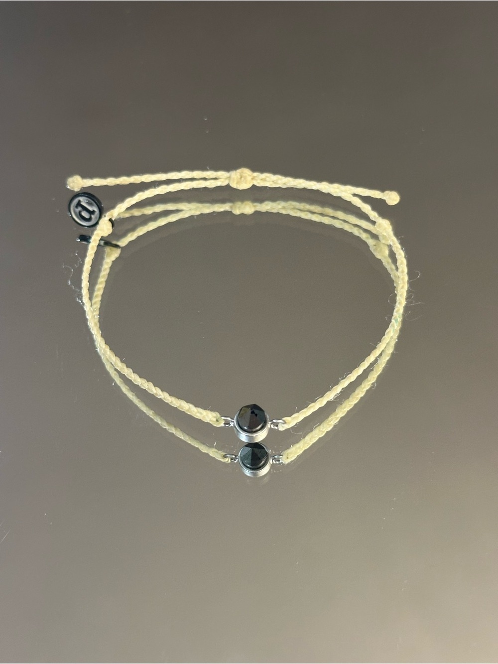 Pura Vida. Pale Yellow Braided Bracelet with Black Disc Charm